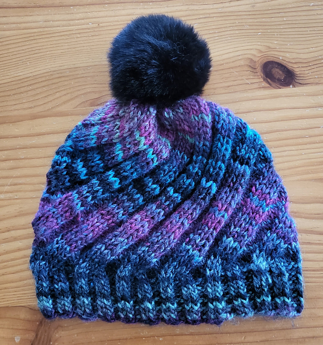 Beanie - black with shades of grey, blue,and pink with black pom pom