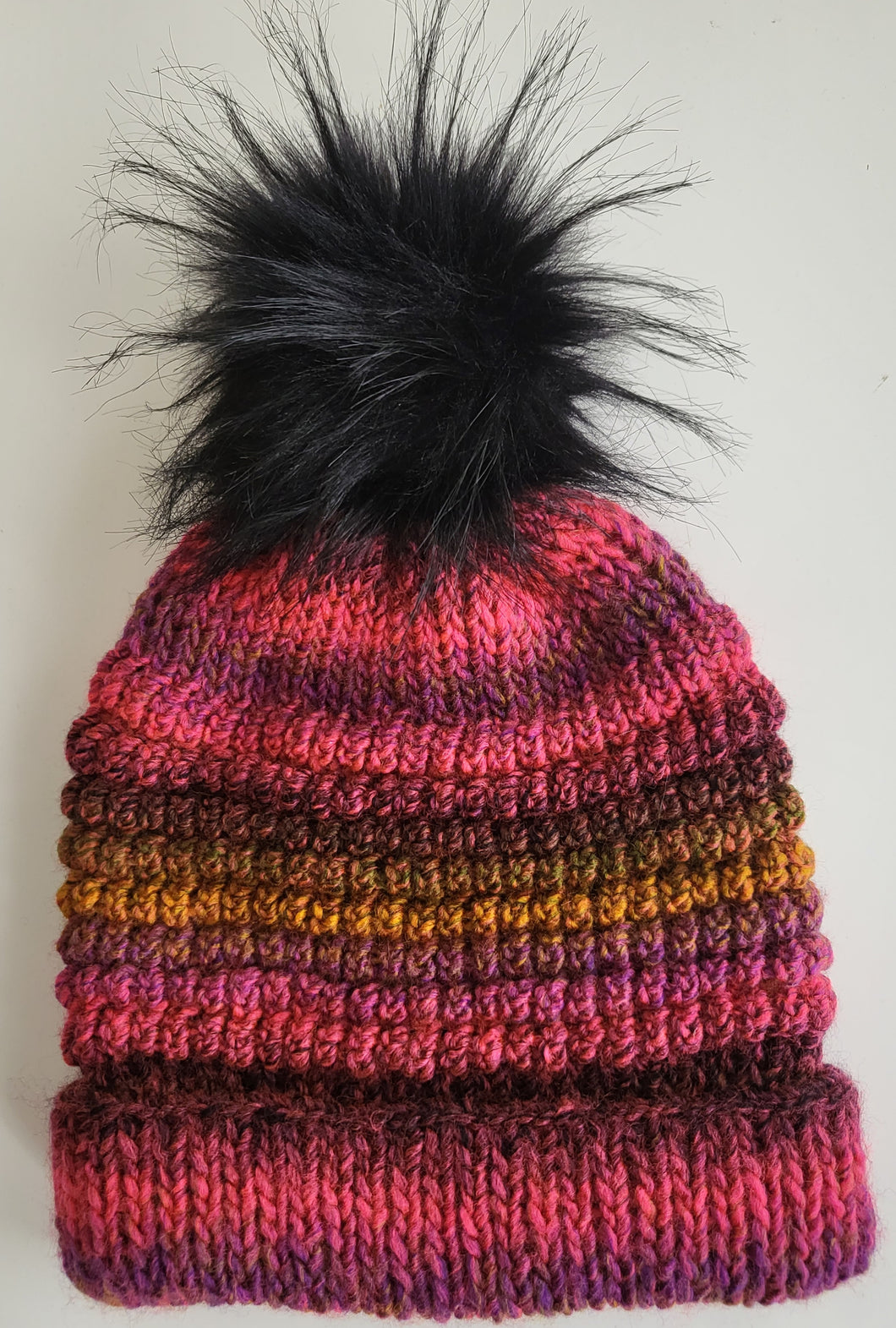 Pink, mauve and rust beanie with black pom